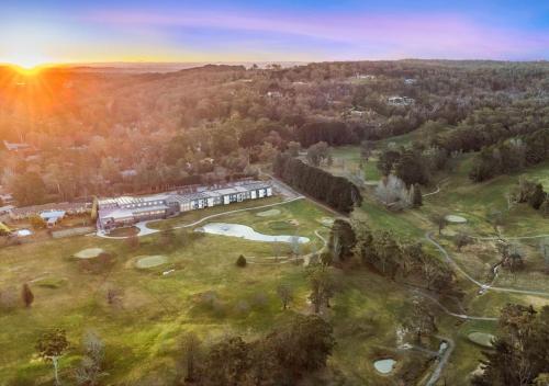 an aerial view of a golf course with the sun setting at Park Proxi Gibraltar Bowral in Bowral