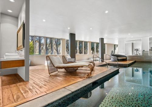 a living room with a swimming pool and a house at Park Proxi Gibraltar Bowral in Bowral