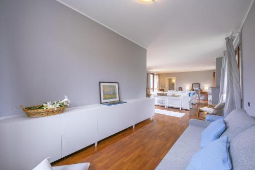 a living room with white walls and a couch at Villa Paola Tremezzo in Tremezzo