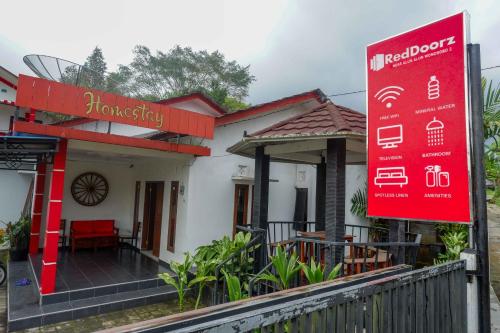a house with a red sign in front of it at RedDoorz near Alun Alun Wonosobo 2 in Wonosobo