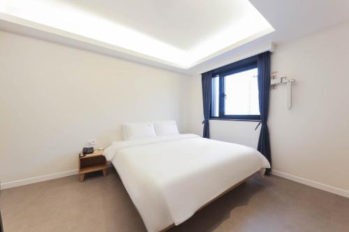 Postel nebo postele na pokoji v ubytování Bonatree Hotel