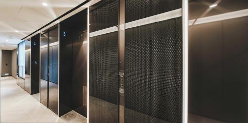 a walk in closet with black walls and glass doors at The Stellar in Hong Kong