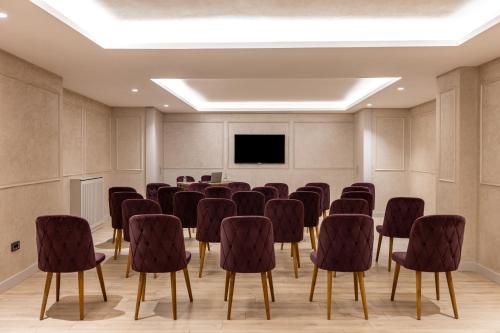 a conference room with chairs and a flat screen tv at Carina Gold Hotel And Restaurant in Istanbul