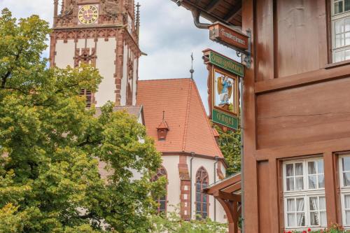 a building with a clock tower in the background at Hotel-Gasthaus Goldener Engel in Glottertal