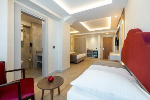a bedroom with a bed and a living room at Carina Gold Hotel And Restaurant in Istanbul