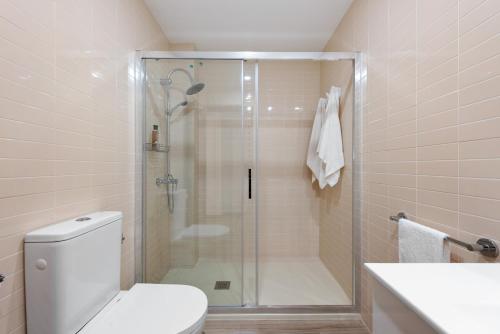 a bathroom with a shower with a toilet and a sink at Casa Mar de frente in Málaga