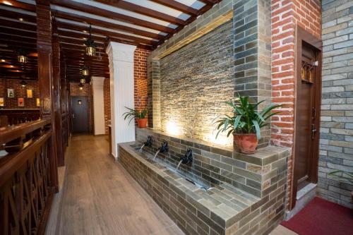 a brick wall in a restaurant with plants on it at Airport Himalaya Boutique Hotel in Kathmandu