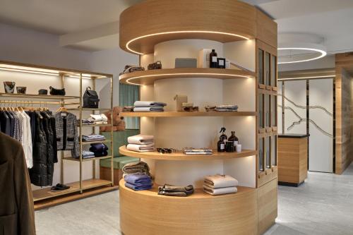 a shop with a wooden display case with clothes at Hotel GRACE LA MARGNA ST MORITZ in St. Moritz