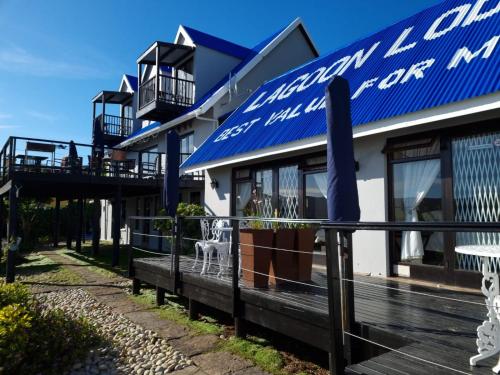 a building with a blue and white sign on it at Lagoon Lodge in Knysna