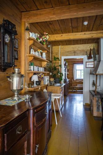 a kitchen with wooden walls and a wooden floor at Sioło Budy in Budy