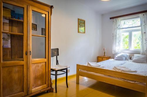a bedroom with a bed and a large window at Sioło Budy in Budy