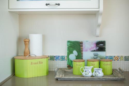 a kitchen with a shelf with jars and vases at הים פוגש את ההר- בית בלב הגליל Sea & Mount in Adamit