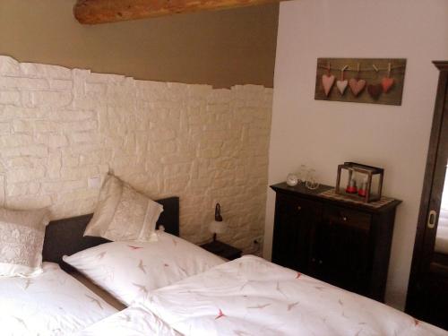 ein Schlafzimmer mit einem Bett und einer Ziegelwand in der Unterkunft Am Schiefen Turm in Bad Frankenhausen