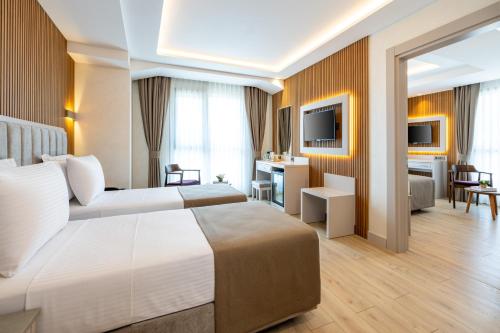 a hotel room with two beds and a living room at Carina Gold Hotel And Restaurant in Istanbul