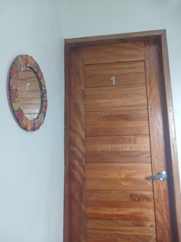 a wooden door with a mirror on a wall at Strandhaus Condotel in Moalboal
