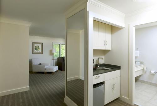 a kitchen with a glass door leading into a living room at Topnotch Resort in Stowe