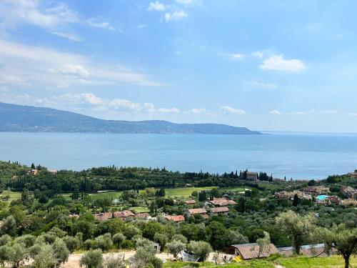 a view of a town and the water at Colago Private Villas Lake Garda in Toscolano Maderno