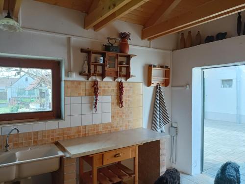 a kitchen with a sink and a window at Ferienhaus Somloi Sellö in Somlószőlős