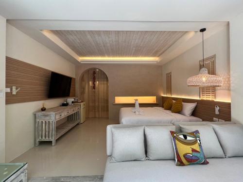 a living room with two beds and a couch at Amity Beach Resort in Koh Samui 