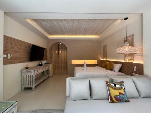 a living room with two beds and a couch at Amity Beach Resort in Lamai