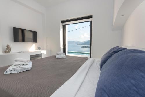 a bedroom with a bed with a view of the ocean at Shape-Infinity in Kalymnos