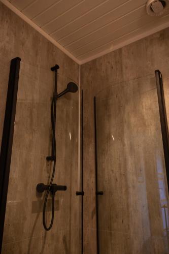 a shower in a bathroom with a shower head at Skanckegårdene AS in Røros