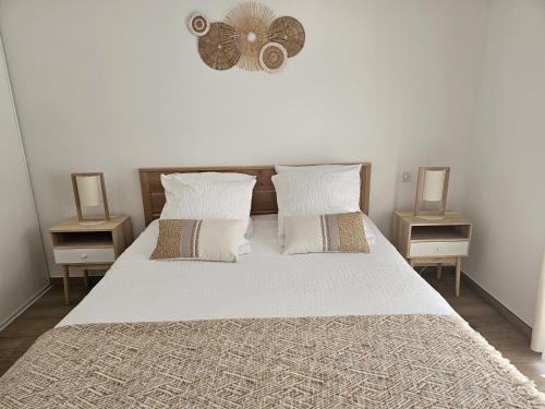 a bedroom with a large bed with two night stands at Villas Chléa in Lucciana