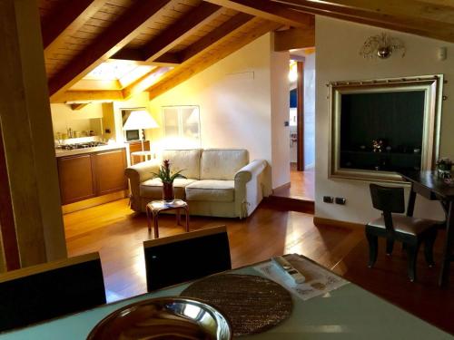 ein Wohnzimmer mit einem Sofa und einem Tisch in der Unterkunft Villa Sasso Il Bianco Varese Lake in Comerio