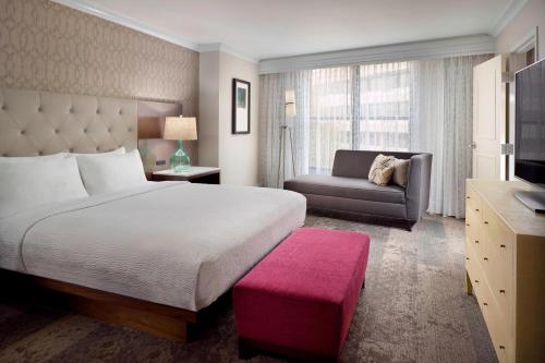 a hotel room with a bed and a couch at Courtyard Atlanta Decatur Downtown/Emory in Decatur