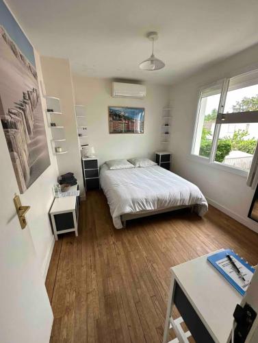 une chambre avec un lit et un bureau dans l'établissement Villa des Palmiers, Chambre n°1, Lit double, à Villeneuve-sur-Lot