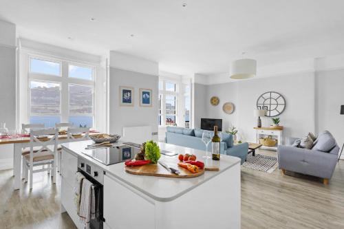 a white kitchen and living room with a counter top at THE ANGEL 1 BEST VIEWS IN DARTMOUTH in Dartmouth