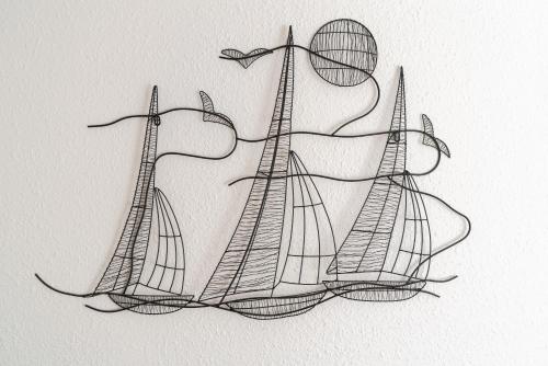 a drawing of three windmills on a wall at Maison de pecheur la rose des vents in Valras-Plage