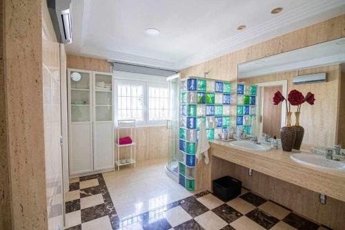 un ampio bagno con due lavandini e uno specchio di lujosa villa en Alhaurin de la Torre 7 dormitorios ad Alhaurín de la Torre
