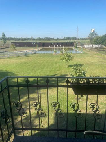 a view of a park from a balcony with a fence at Kastélykert Fogadó in Szeged
