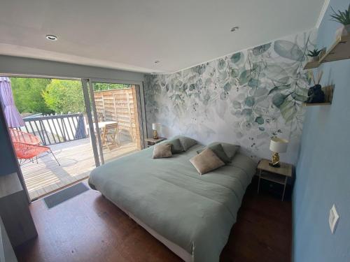 a bedroom with a bed and a sliding glass door at Studio 8 in Sancourt