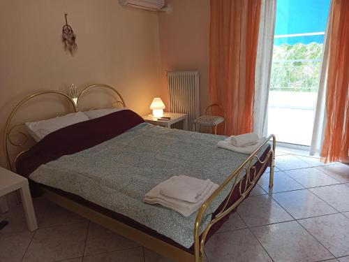 1 dormitorio con cama y ventana grande en Διαμέρισμα 110 Μ στον Λαγκαδά, en Langadas