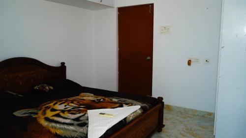 a bedroom with a tiger bed with a towel on it at Bacardi House in Chennai