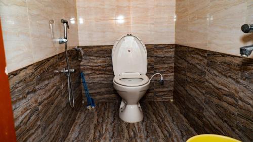 a bathroom with a toilet in a shower stall at Bacardi House in Chennai