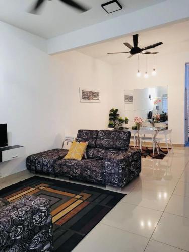 a living room with a couch and a table at Andra Homestay KLIA in Sepang