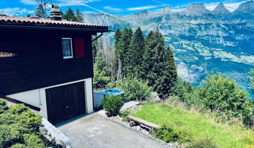 a building with a door on the side of a mountain at Chalet Wiesehockli - CharmingStay in Flumserberg