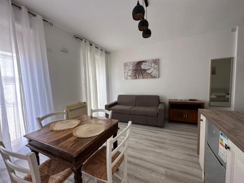 a living room with a table and a couch at CagliariParadiseApartment it Marina in Cagliari