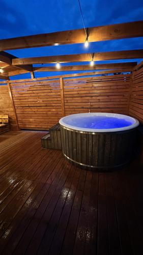 a large hot tub in a room with a wooden floor at Ranczo Słajszewo in Słajszewo