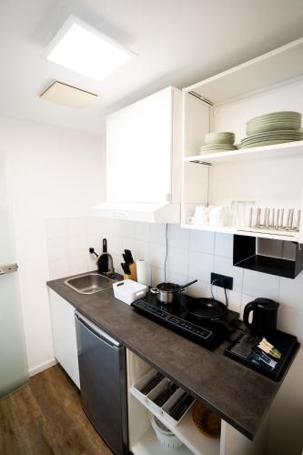 a kitchen with a sink and a counter top at AP Hotel Mannheim Viernheim in Viernheim