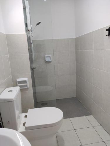 a bathroom with a shower and a toilet and a sink at FA Homestay Alanis, Near KLIA in Sepang