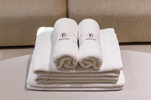 a pile of towels sitting on top of a table at Brown Dot Hotel Daegu Suseong in Daegu