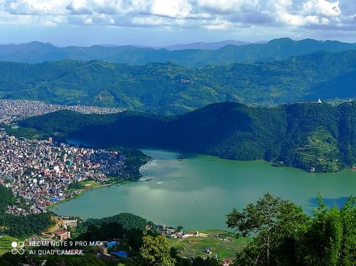 an aerial view of a lake in a city at Lake View Lodge Sarangkot in Pokhara