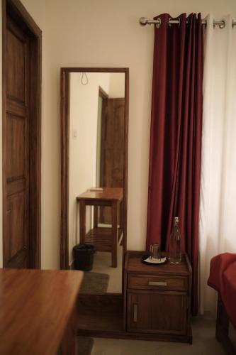 a living room with a mirror and a wooden dresser at SkyLounge Residency in Trivandrum