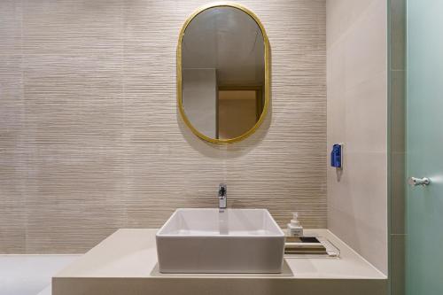 a bathroom with a white sink and a mirror at Brown Dot Hotel Daegu Suseong in Daegu