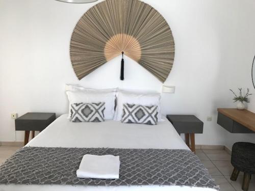 a bedroom with a large bed with a clock on the wall at Sea & Sun Paros in Naousa