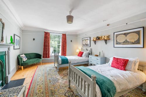 a bedroom with two beds and a fireplace at The House of Black & White in Great Torrington